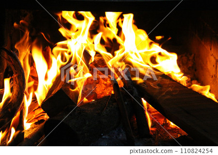 Firewood and flames burning in a Brazilian fireplace Firewood and flames burning in a Brazilian fireplace 110824254