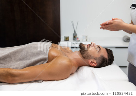 Young man having relaxing procedures in a massage salon Young man having relaxing procedures in a massage salon 110824451