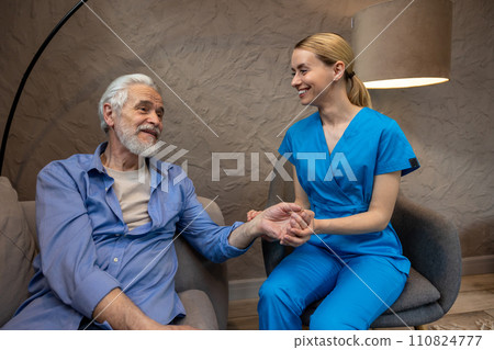 Nurse checking pulse by hand in medical center. 110824777