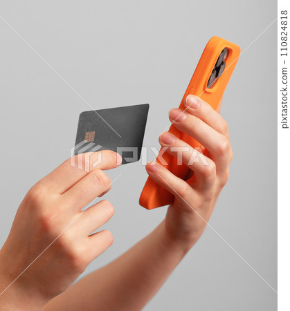 Berlin Germany January 21 2024 Bank card and mobile phone in hands for paying online, entering data Berlin Germany January 21 2024 Bank card and mobile phone in hands for paying online, entering data 110824818