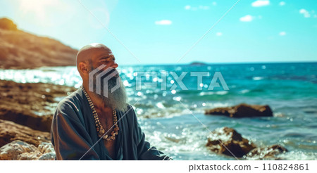 Old bearded monk meditating on the seashore, copy space for healthcare and mental health concept, individual yoga exercise 110824861