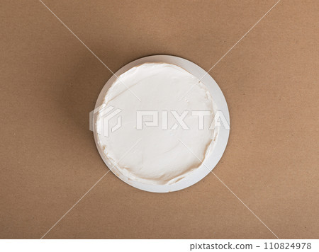 Simple bento cake mockup, top view on cream surface Simple bento cake mockup, top view on cream surface 110824978