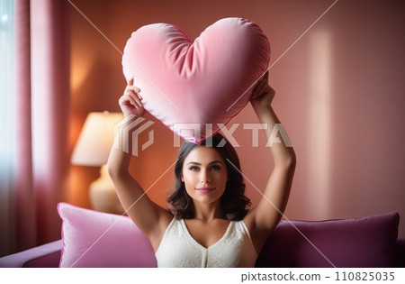 Happy young girl holding heart shaped pink pillow. Banner perfect for Valentines Day card, romantic themed design, voucher, greeting card, print. Concept love. Copy space. Happy young girl holding heart shaped pink pillow. Banner perfect for Valentines Day card, romantic themed design, voucher, greeting card, print. Concept love. Copy space. 110825035