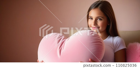 Happy young girl holding heart shaped pink pillow. Banner perfect for Valentines Day card, romantic themed design, voucher, greeting card, print. Concept love. Copy space. 110825036