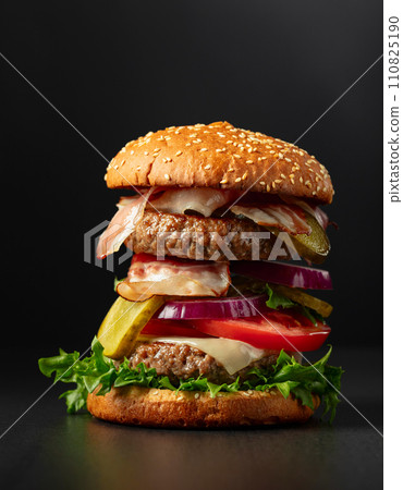 Fresh tasty burger on a black background. 110825190