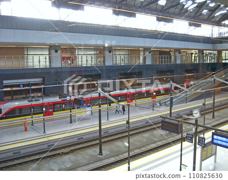 Electric train leaving station in evening. Train leaving station Electric train leaving station in evening. Train leaving station 110825630