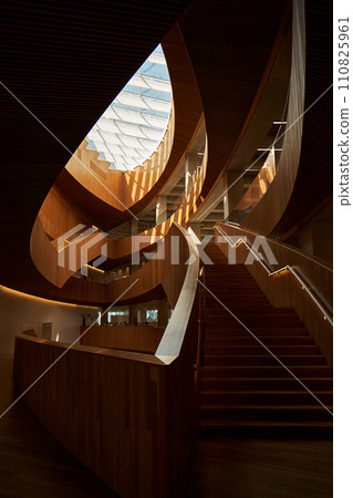 Design of the central public library in Calgary. Modern art interior design with wooden walls and glass ceiling. Design of the central public library in Calgary. Modern art interior design with wooden walls and glass ceiling. 110825961