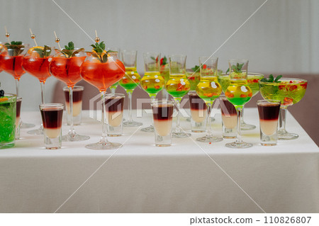 Welcome drink with cocktail glasses and drinks at an event. Alcoholic beverages at a wedding Welcome drink with cocktail glasses and drinks at an event. Alcoholic beverages at a wedding 110826807