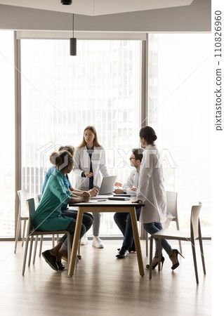 Young female chief doctor holding meeting with diverse medical team Young female chief doctor holding meeting with diverse medical team 110826960