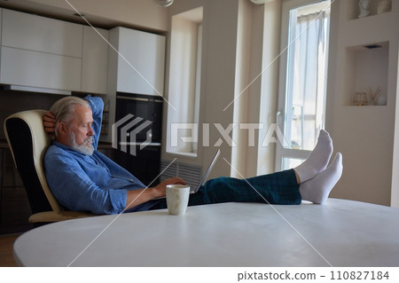 Serious mature older man client sits on couch in room talking on video call using laptop complain about bad service product. Senior aged businessman talk at online conference. Shooting in slow motion. 110827184