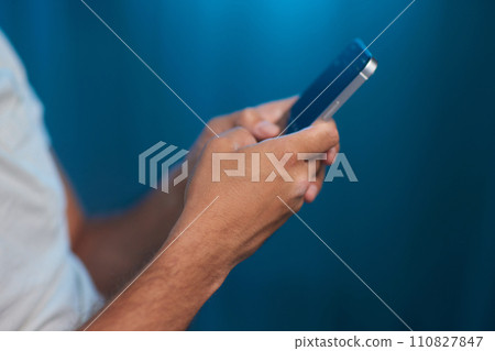 Portrait of a cheerful man using smart phone at home office. Portrait of a cheerful man using smart phone at home office. 110827847