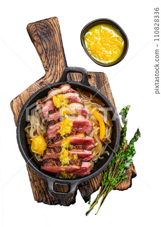 Grilled duck meat breast fillet steak with noodles and tangerines sauce. Isolated on white background, Top view. 110828336