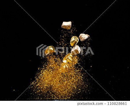 Gold Ingot Chinese Money bar token fly with dust particle in air. Chinese new year Yuanbao gold ingots floating to golden money sand particle. Language is wealthy prosperity. Black background isolated 110828661