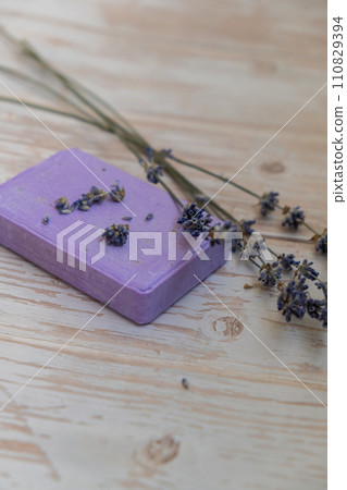 Handcrafted purple lavender soap with lavender flowers. Natural hydrating moisturiser softness cosmetic. Organic calming beauty skincare product. Herbal self care wellness alternative soap Handcrafted purple lavender soap with lavender flowers. Natural hydrating moisturiser softness cosmetic. Organic calming beauty skincare product. Herbal self care wellness alternative soap 110829394