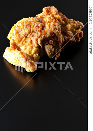 Fried chicken photographed against a black background 110829604