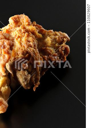 Fried chicken photographed against a black background 110829607