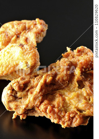 Fried chicken photographed against a black background Fried chicken photographed against a black background 110829620