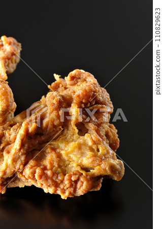 Fried chicken photographed against a black background 110829623