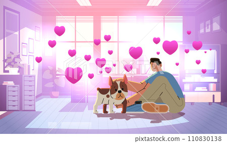 young man in love spending time with dog male owner and cute domestic animal friendship with pet valentines day celebration 110830138