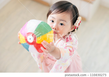 A 1-year-old child catching paper balloons, an old game A 1-year-old child catching paper balloons, an old game 110830273