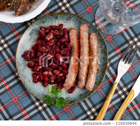 Traditional Catalan dish of fried pork sausage Butifarra with side dish of beans Traditional Catalan dish of fried pork sausage Butifarra with side dish of beans 110830644