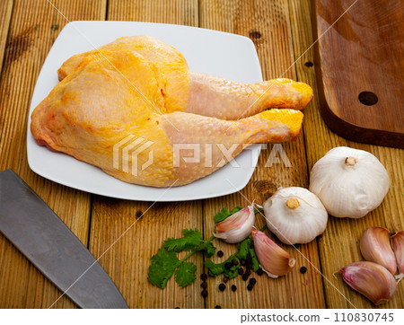 Raw chicken leg quarters on wooden table Raw chicken leg quarters on wooden table 110830745
