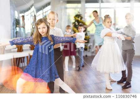 New Year performance - beautifully dressed children dance classical dances at Christmas ball 110830746