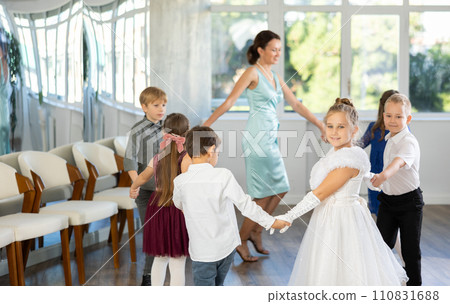 Children holding hands and dancing in round dance - festive pastime Children holding hands and dancing in round dance - festive pastime 110831688