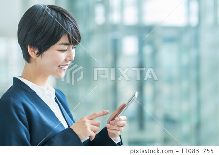 A business woman with a smartphone. A business woman with a smartphone. 110831755