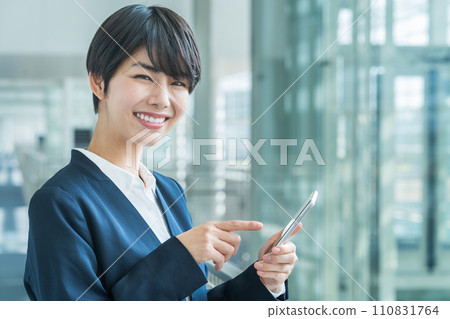 A business woman with a smartphone. 110831764