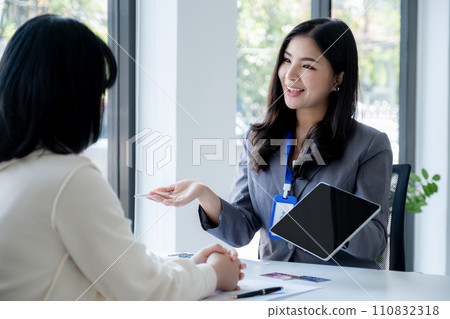 Employees present with mock up credit card payments to business customers. Ready to provide discounts and life insurance 110832318