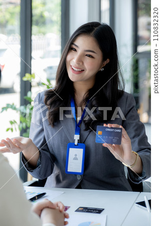 Employees present with mock up credit card payments to business customers. Ready to provide discounts and life insurance Employees present with mock up credit card payments to business customers. Ready to provide discounts and life insurance 110832320