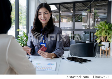 Employees present with mock up credit card payments to business customers. Ready to provide discounts and life insurance 110832322