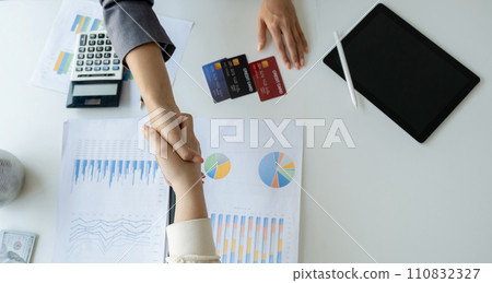 Hand shake after Employees present with mock up credit card payments to business customers. Ready to provide discounts and life insurance Hand shake after Employees present with mock up credit card payments to business customers. Ready to provide discounts and life insurance 110832327