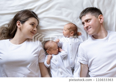 Newborn Identical twins on the bed,emotions of kids. Infant Babies With Copy Space Newborn Identical twins on the bed,emotions of kids. Infant Babies With Copy Space 110833363