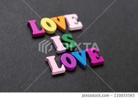 words love is love, notepad with chalk drawn heart. Valentine's day concept words love is love, notepad with chalk drawn heart. Valentine's day concept 110833565