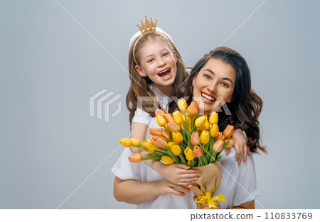 Daughter and mother with bouquet of flowers 110833769