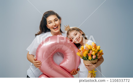 Daughter and mother with bouquet of flowers 110833772