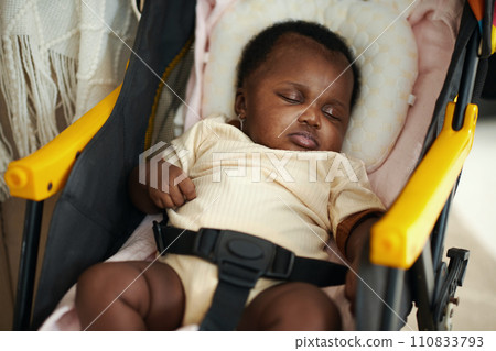 Little Black baby girl sleeping in stroller 110833793
