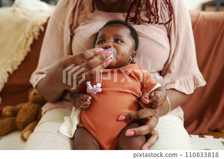 Mother giving pacifier to almost crying newborn baby Mother giving pacifier to almost crying newborn baby 110833818