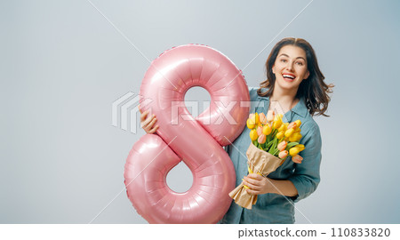 woman with flowers and balloon in shape of eight woman with flowers and balloon in shape of eight 110833820