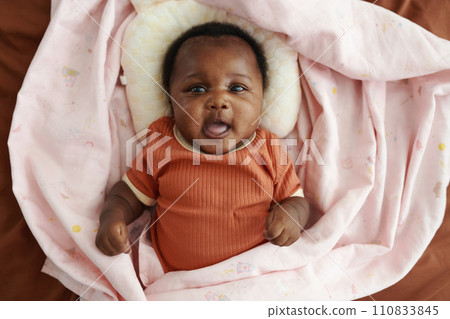 Portrait of Black little girl in soft pink blanket, top view 110833845