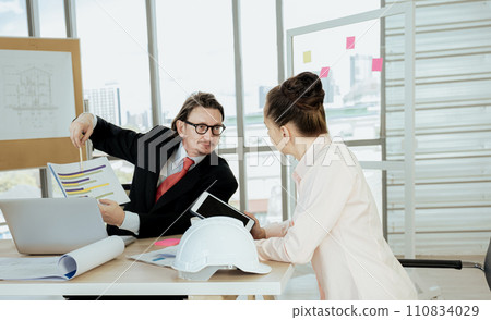 Engineer team meeting to inspect the construction blueprint drawings, work plan and distribute work before starting the building 110834029