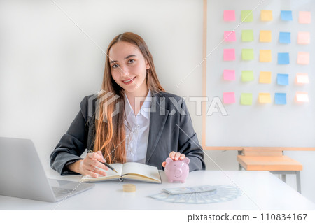 Business woman hand putting coin into piggy banks with gold coins pile growth graph, Saving money for future investment plan and retirement fund concept Business woman hand putting coin into piggy banks with gold coins pile growth graph, Saving money for future investment plan and retirement fund concept 110834167