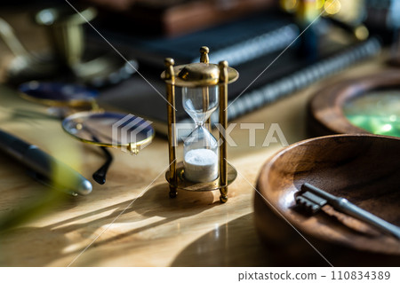 Snap of desk with hourglass 110834389