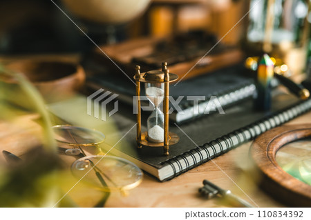 Snap of desk with hourglass 110834392