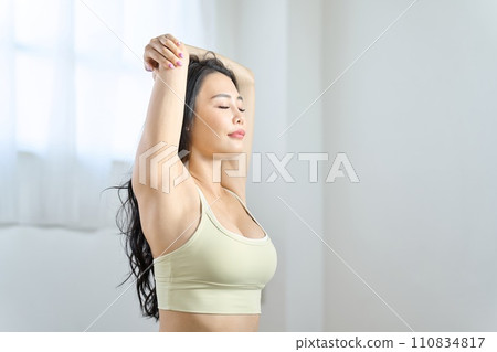 A woman stretching his upper body A woman stretching his upper body 110834817
