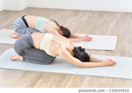 two women doing child's pose 110834820