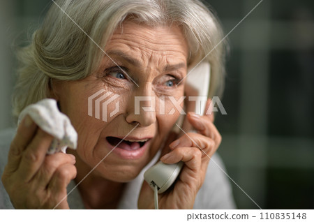 Portrait of sick senior woman talking on the phone Portrait of sick senior woman talking on the phone 110835148