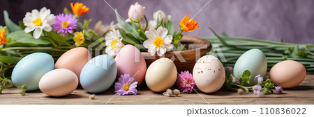 Multicolored Easter eggs on the table with spring flowers - Easter banner with a space for text. AI generated 110836022